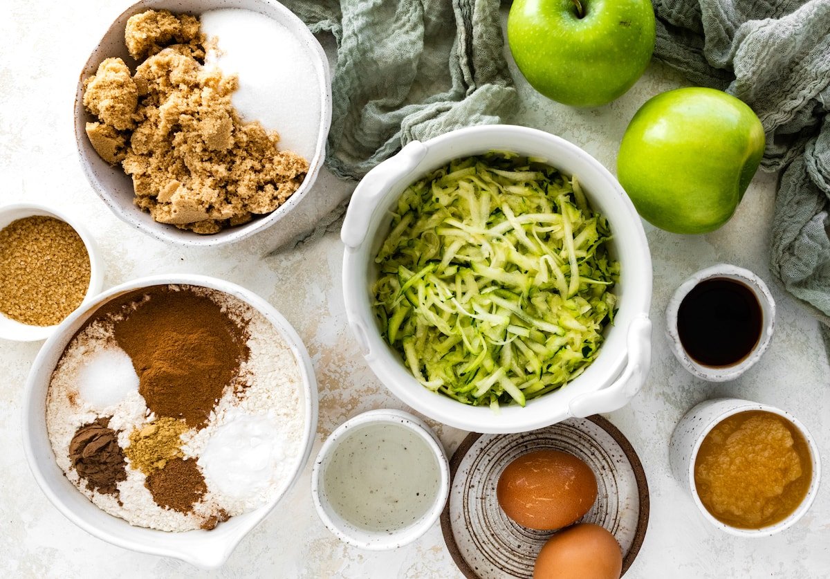 ingredients in bowls to make apple zucchini bread. 