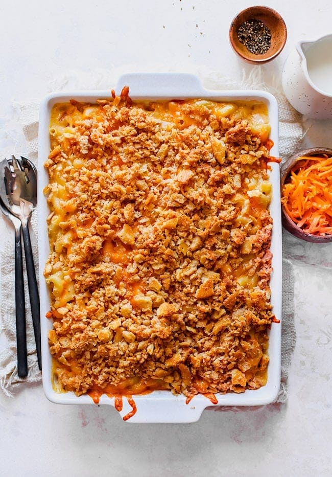 Baked Mac and Cheese with cracker topping in white baking dish. 