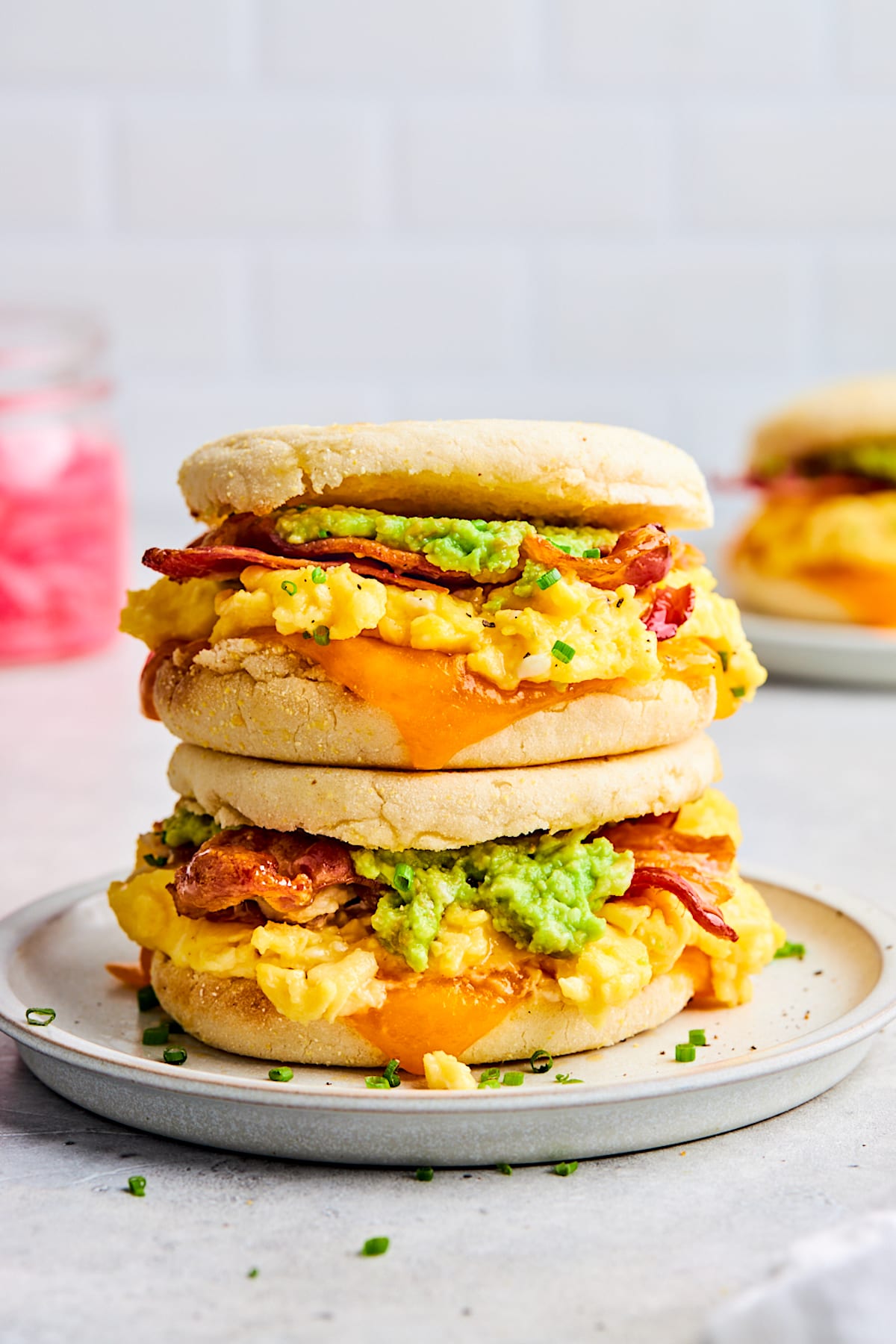 2 breakfast sandwiches stacked on top of each other. 