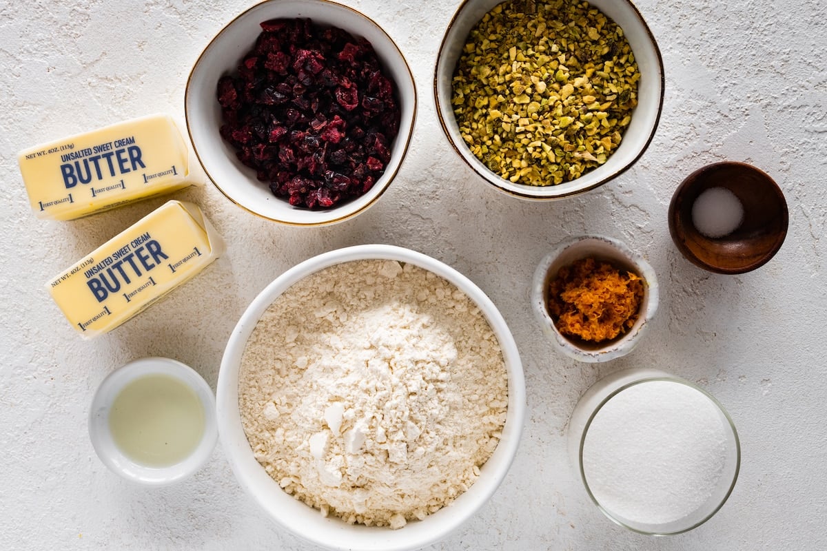 ingredients in bowls to make cranberry orange pistachio shortbread. 