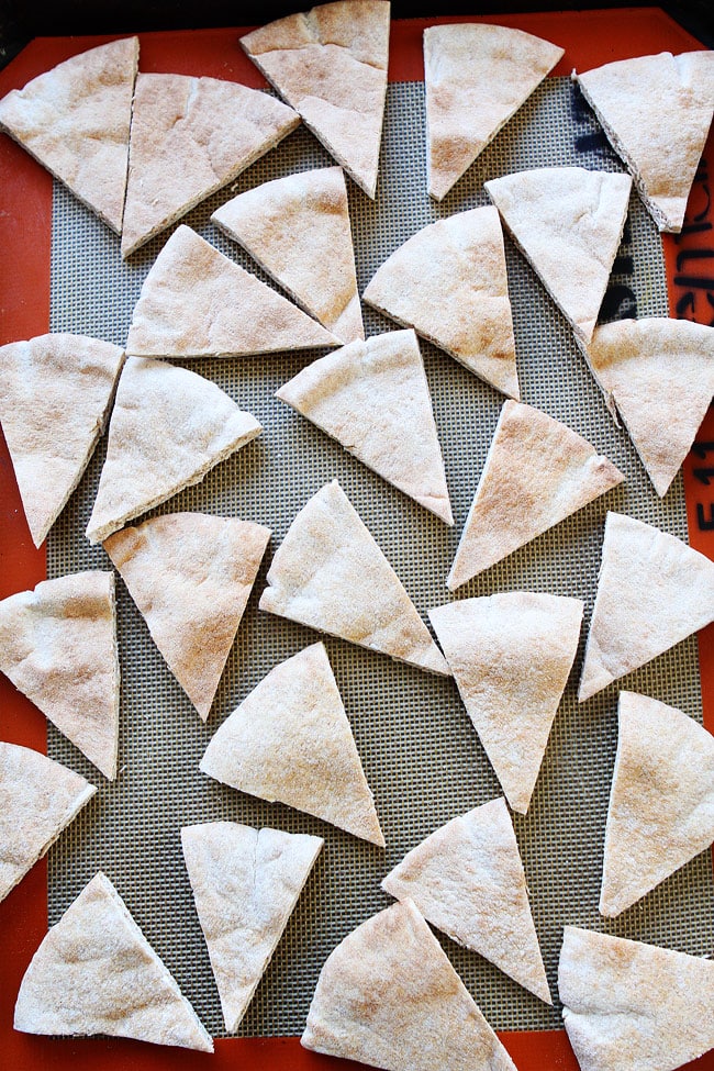 pita bread cut into triangles on baking sheet with Silpat. 