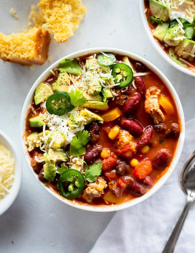 turkey chili in bowl with toppings.